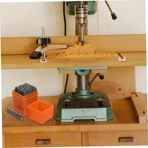 Drill press setup with an Awesome 37 Piece Metal Stamping Kit With Letters Numbers Heart Symbols And Punches for DIY crafting.