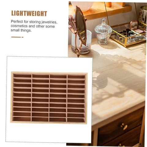 Totally Game Changing Wood Jewelry Tray With Plush Suede Grid Organization Board featuring a 40-slot design on a desk.