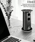 Auto Rises Pop Up Outlet Slick Aluminum Desk Power Strip With Swappable Modules Quick Charge Ports And Optional Speaker Zero Clutter Vibe Ideal For Kitchen Islands Or Office Desks Looking Sharp, showcasing a black aluminum power strip on a desk.