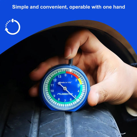 32nds Tire Tread Depth Gauge With Glow In The Dark Luminescent Dial being used on a car tire by a mechanic's hand.