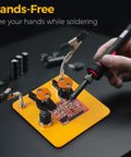Dual Clamp Soldering Helper Stand with Quick Release Third Hand for electronics PCB repair on yellow base in use.