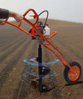 Gas-powered hand-push earth auger with orange frame and single wheel, 3.15-inch drill bit included