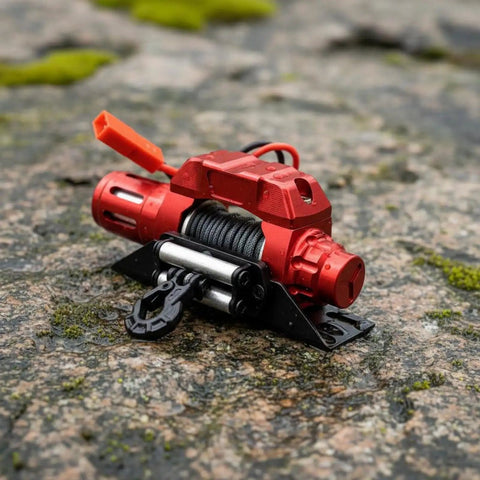Heavy Duty 1/10 Scale CNC Metal Electric Winch For RC Crawler Cars Off-Road Rigid Rock Crawling Setup With Realistic Pulling Power And Smooth Performance on rocky surface.