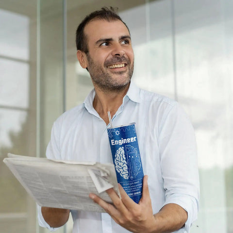 Smiling man holding newspaper and stainless tumbler from Six Piece Engineering Graduation Gift Set For Men