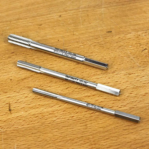 Three Piece Metric Wood Tap Set For Drill Pro Grade M6 X 1.0 M8 X 1.25 M10 X 1.5 High Speed Steel With Chrome Armor Plating displayed on table