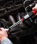 Person using Heavy Duty Digital Torque Wrench With Buzzer And LED Alerts For Real Time Torque Readouts In Foot Pounds And Newton Meters ISO 6789 Certified With Calibration Certificate Half Inch Drive 14.8 To 147.5 Foot Pounds For Pros And DIYers in automotive engine
