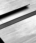 36 Inch Stainless Steel Linear Shower Drain With Tile Insert Tray And Flat Cover, visible on a tiled floor, matte black finish.