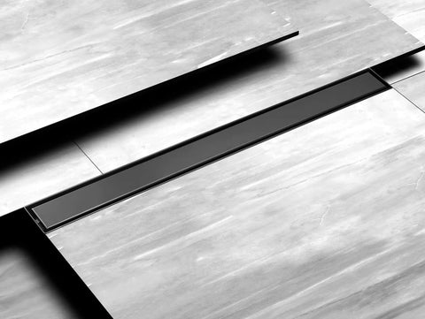 36 Inch Stainless Steel Linear Shower Drain With Tile Insert Tray And Flat Cover, visible on a tiled floor, matte black finish.