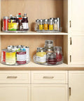 2 Pack Lazy Susan Turntable Organizer 9.5 Inch Spice Rack in kitchen cabinet with cans and jars displayed on clear non-slip trays