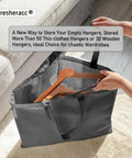 Triangle Hanger Organizer Bag For No Fuss Space Saving Closet Chaos with handles holding wooden hangers, shown in use.