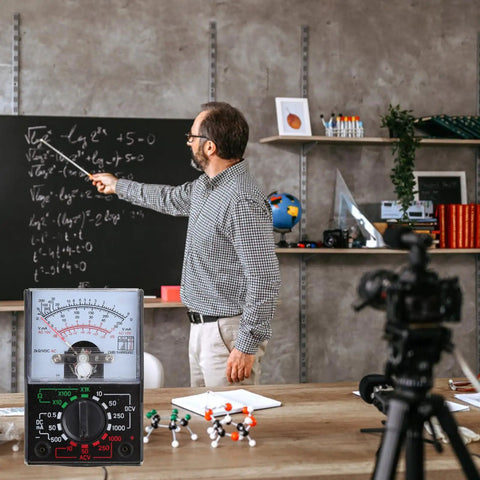 Teacher using Multipurpose Analog and Digital Multimeter Handheld Power Meter Voltage Tester in classroom setting