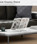 Clear Acrylic Book Stand With Adjustable Angle holding a magazine on a coffee table in a living room setting