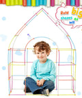 Child playing with Straw Constructor STEM Building Toy Kit With 600 Pcs Interlocking Gear Blocks, sitting inside colorful frame