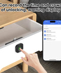 Smart Cabinet Lock With Fingerprint, Bluetooth App And Apple Watch Unlock on wooden drawer with smartphone app display