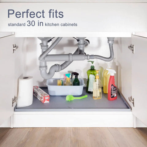 Under Sink Silicone Mat 28 By 22 Inch Waterproof Flexible Liner With Drain Hole Gray For Kitchen And Bathroom Cabinets Fits Most 30 Inch Cabinets Durable Spill Proof Protector No Fuss Cleanup placed under kitchen sink with cleaning supplies on top