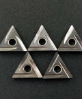 Set of five silver TNMG carbide inserts with central mounting hole for lathe turning