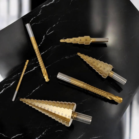 Six Piece High Speed Reaming Pagoda Sawtooth Drill Bit Set With Titanium Plating In Box For Metal And Wood, displayed on marble surface
