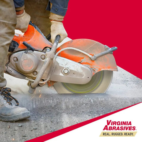 Worker using 14 Inch Supreme Pro High Speed Diamond Blade For Concrete And Asphalt Wet Or Dry Cutting Laser Welded Tough Grit Evolutionary Design 14 Inch By.125 Inch By 1 Inch Segments 20mm To 10mm on asphalt