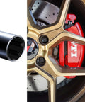 Hella Tough 7 Spline Lug Nut Key And Socket Wrench For Fuel Wheels And Rims M14 Thread next to a gold wheel with red brake calipers.