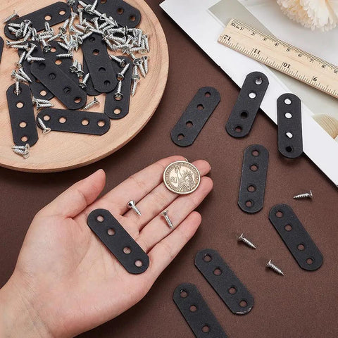 Hand holding Heavy Duty Wood Bracket Kit With 20 Flat Metal Joining Plates Black 2.16 X 0.71 Inch And 80 Screws