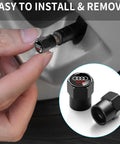 Audi Tire Valve Stem Caps 4 Pack Aluminum Alloy Metal Air Caps For Car Wheels Black Finish Durable Protect Valves From Leaks And Wear Easy Install Now, showing close-up of cap installation on car wheel.