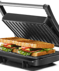 Aigostar Silver 1000W Panini Press Grill With Ceramic Nonstick Plates for even cooking sandwiches with lettuce and tomato.