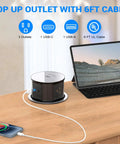 Pop Up Countertop Power Outlet With 20W USB C Fast Charge Hidden Recessed Socket Four AC Plugs And One USB A Port Top Qi Wireless Charger For Kitchen Four Point Seven Inch Built In Pop Up Outlet Black shown on countertop powering devices