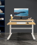 Heavy Duty Dual Tier Standing Desk With Smooth Crank Lift Tough Locking Wheels And Roomy Carbon Steel Desktop For Home Office featuring a light wood top and white frame.