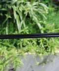 Person holding Heavy Duty Garden Drip Irrigation Hose For Greenhouse And Lawn, Flexible Black PVC One Quarter Inch Tubing