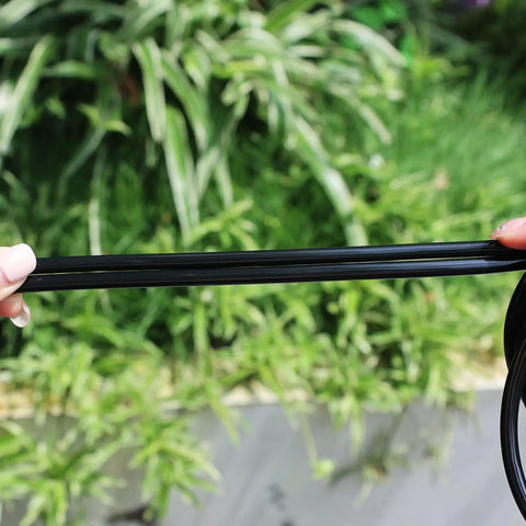 Person holding Heavy Duty Garden Drip Irrigation Hose For Greenhouse And Lawn, Flexible Black PVC One Quarter Inch Tubing