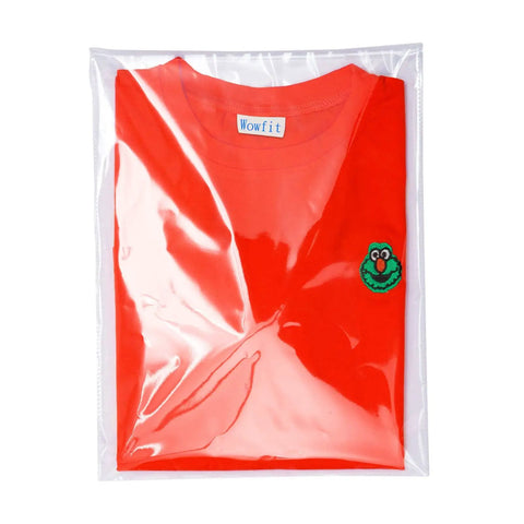 Clear 9x12 Cellophane Bags 100 Count Resealable Self Sealing Poly Bags For Clothes Shirts Pants Food Flyers Heavy Duty Reinforced Sides Ideal For Gift Wrap And Storage And More holding a red shirt