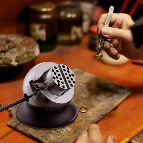 Jeweler using 3 Inch Ball Vise Engraving Setting Tool With 360 Degree Rotation Pro Grade Jewelry Engraving Block And Attachment Set on workbench.