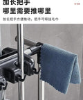 Side view of a Floor Standing Mop And Broom Organizer Rack With Foldable Hooks, showing stainless steel frame and cleaning tools.