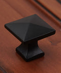 Modern Square Cabinet Knob 1-1/4 Inch Solid Cast Iron, Rust-Resistant Black Powder Coat on wooden surface