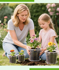 Mother and daughter planting flowers in Clear Nursery Pots With Drainage Trays, 25 Pack Plastic Pots For Plants, Five Sizes.