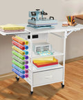 Heavy Duty Three Tier Movable Heat Press Table With Foldable Stand For Heat Transfer Machines Sublimation Printers And Cutting Tasks Hustle Ready Workhorse with fabric rolls and supplies on display.