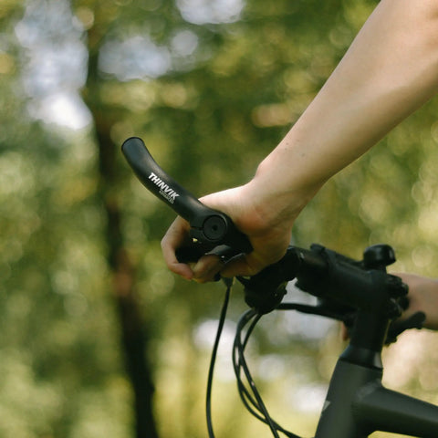 Hand gripping mountain bike handlebar with Mountain Bike Bar Ends In One Piece Aluminum Forged For Strength And Control, 15 cm length.
