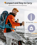 Hiker with orange jacket carrying Phone Tripod Kit With Wireless Remote for Smartphones and Cameras, 62 Inch Selfie Stick on snowy trail