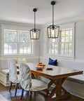 Top Shelf 2 Pack Modern Farmhouse Pendant Lights For Kitchen Island Featuring Matte Black Iron Cage And Clear Glass Shade above dining table.