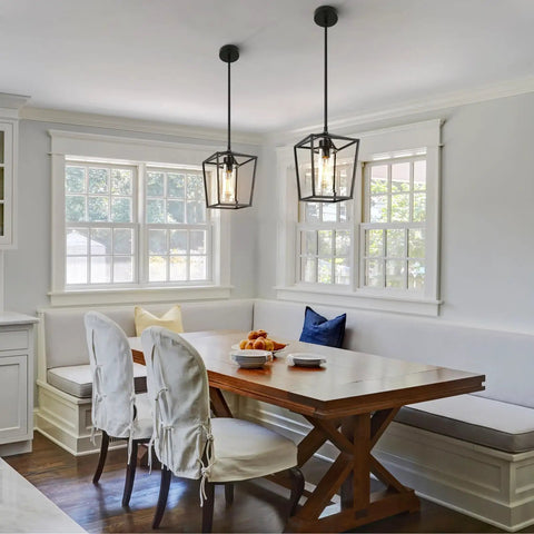 Top Shelf 2 Pack Modern Farmhouse Pendant Lights For Kitchen Island Featuring Matte Black Iron Cage And Clear Glass Shade above dining table.