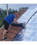 Heavy Duty Self Adhesive Roofing Tape Rock Solid Waterproof Asphalt Membrane Roll used by a person on a tiled roof.