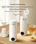 Grab And Go Travel Kettle, 500 Ml Heated Water Cup on a wooden surface with a drink, showcasing its flip lid and design.
