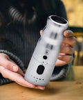 Electric Pepper Grinder with LED Light, Rechargeable and Up to 10X Faster One Touch Operation, shown in matte black held by hands.