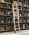Sliding Library Ladder Kit With Retractable Round Tube Track for bookshelves and loft access, installed on black shelves