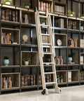Rolling ladder on black track kit in library, part of Sliding Barn Door Hardware Kit With Floor Rollers And Track System Full Set