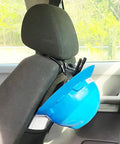 Universal Over The Seat Hard Hat Rack And Headrest Hook for back seat storage holding a blue hard hat on a black car seat