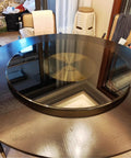 Heavy Duty 39 Inch Round Lazy Susan Turntable For Dining Table Top Hella Smooth Spin 10MM Tempered Safety Glass on dark wooden table.