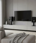 Desktop Speaker Stands Pair With A 7 By 7 Inch Metal Tray And 6 Inch Height next to TV in modern living room setup.
