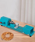 Mini Wood Lathe Machine With A Hella Strong 96W Copper Motor Spinning At 9000 Rpm on a table with wooden beads.
