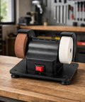 Badass Dual Wheel Bench Grinder With Sturdy Rubber Footed Base on wooden table, compact black design with two wheels for sharpening.
